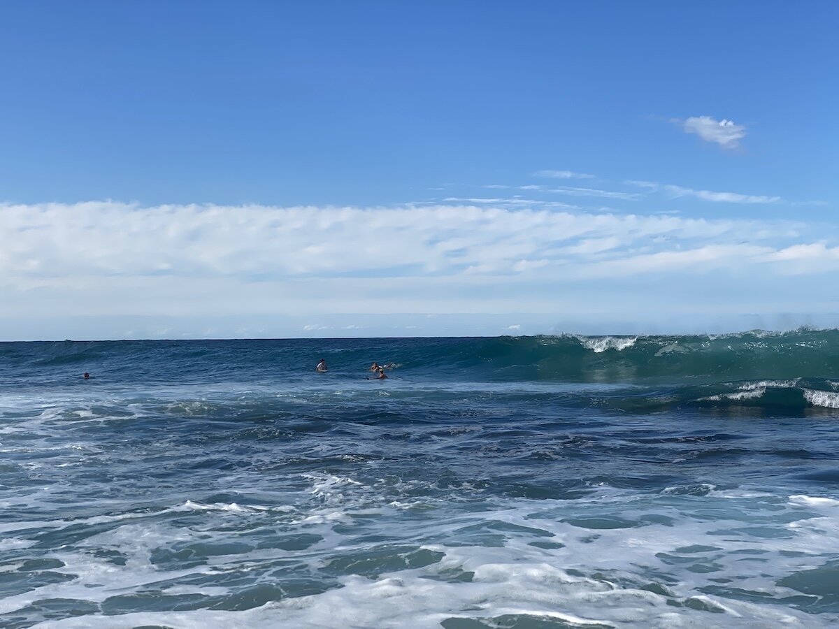 Surfers waiting in the lineup as a wave peaks at Zinkwazi main beach
