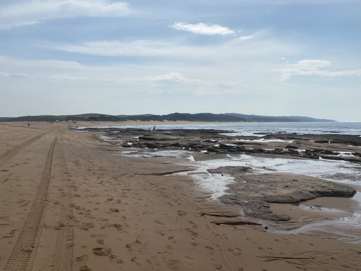 Shallow rocky reef and tide pools along Zinkwazi main beach at low tide