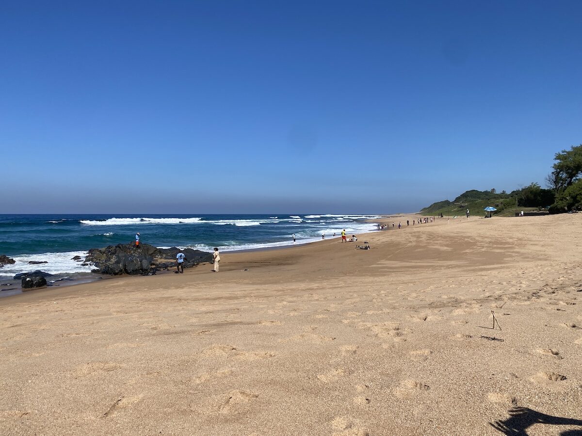 Black Rock beach in winter with clear skies and visitors on the sand, Zinkwazi Beach