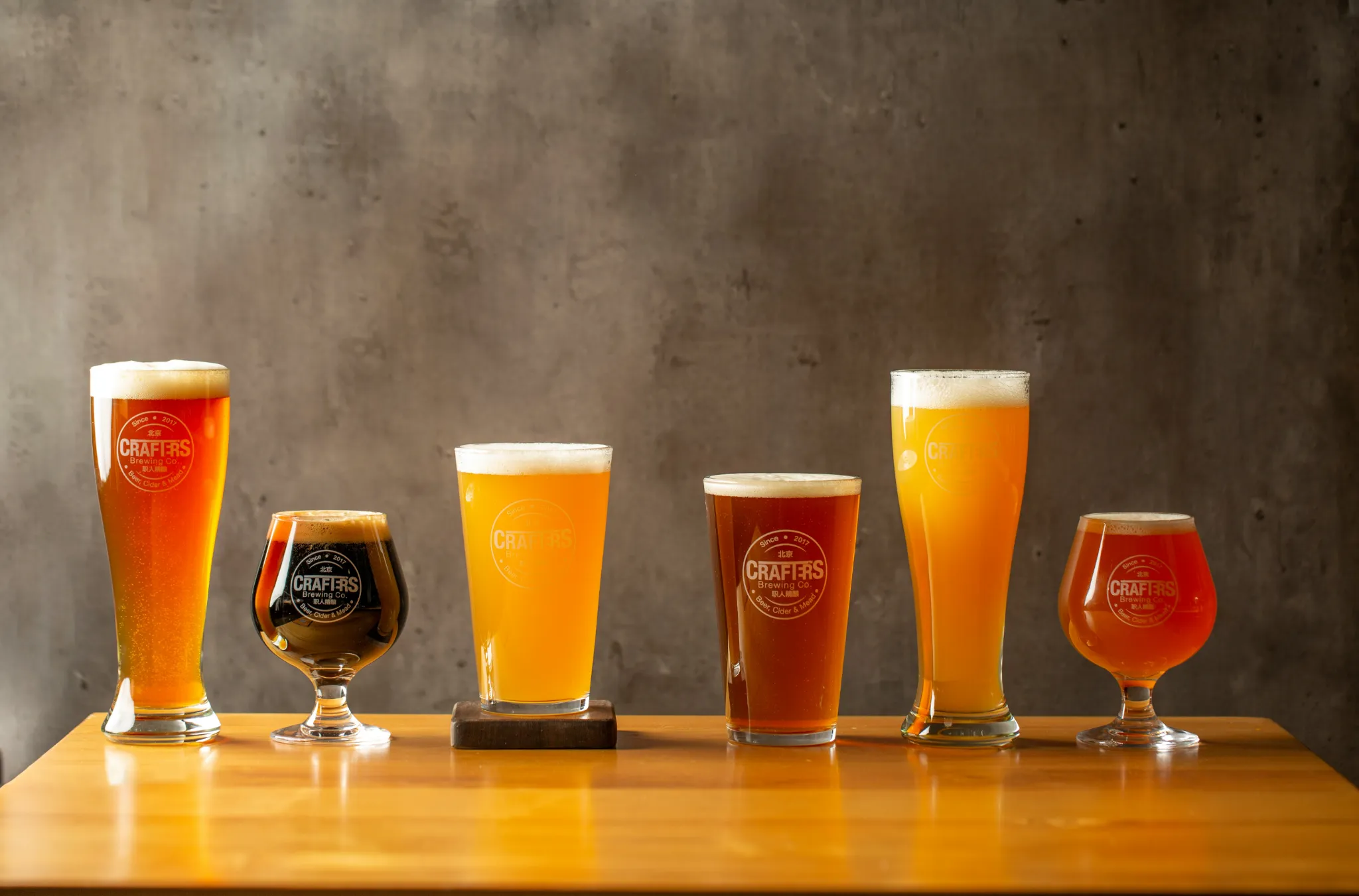 A variety of craft beers in different glasses, showcasing the tasting experiences to be had in Ballito.