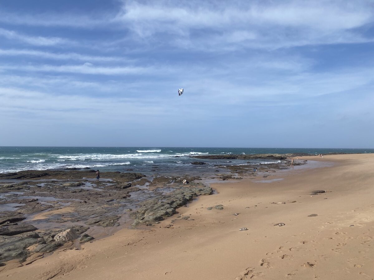 Kiteboarder jumping above the rocky access at Zinkwazi main beach