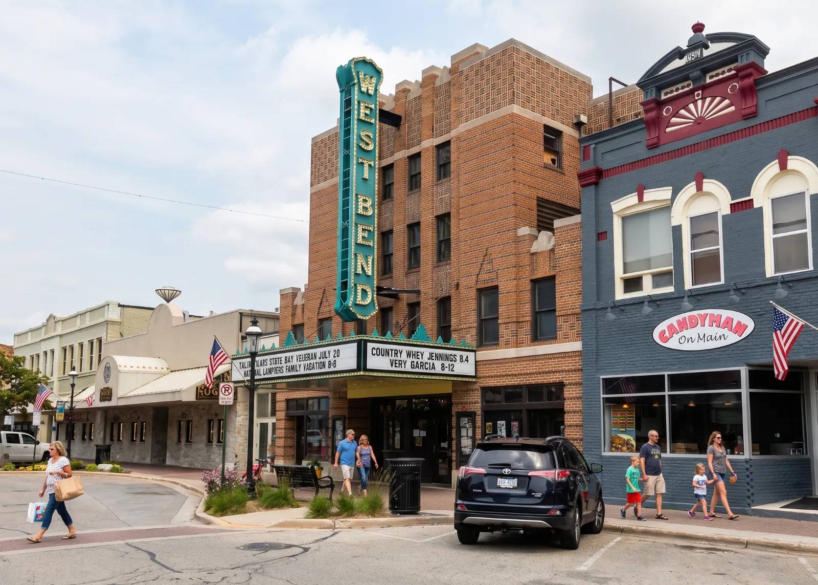 A vibrant street scene at West Bend with historic brick buildings and people strolling the sidewalks on a cloudy day.