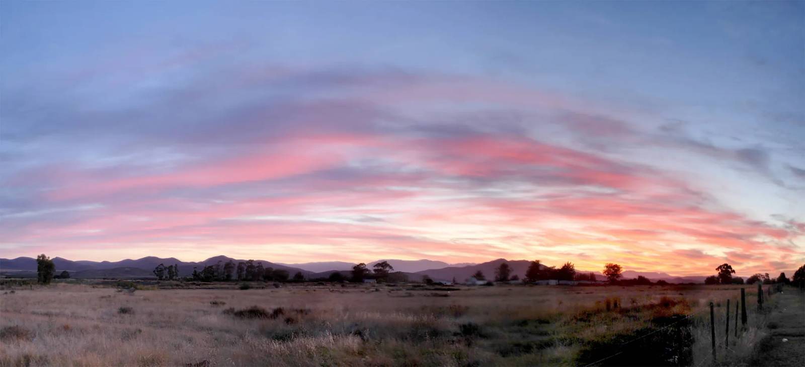 Sunset over the landscape outside Ashton. Photo: Warren Rohner from Cape Town, South Africa (CC BY-SA 2.0).
